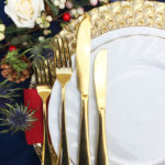 Festive place setting gold charger plate and gold cutlery
